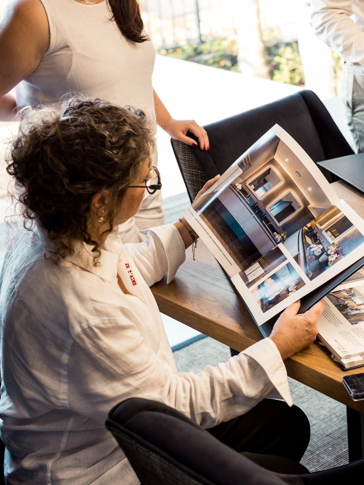 Schané Anderson reviewing the Clifton Splendour project book in the OLALA studio